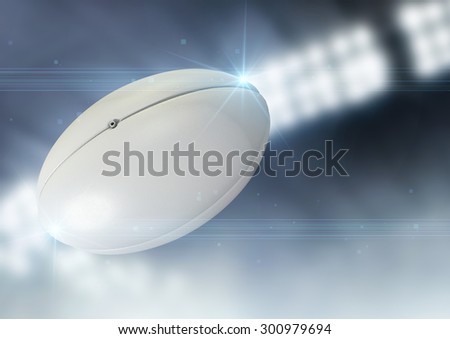 A regular rugby ball flying through the air on an indoor stadium background during the night