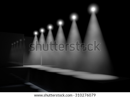 A fashion runway stage lit by a row of spotlights on a dark background
