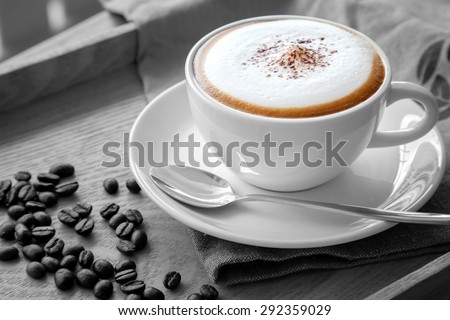A cup of cappuccino in black and white scene