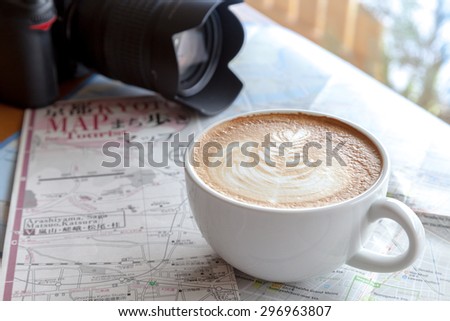 Drinking cafe\' latte and read maps for travel plan
