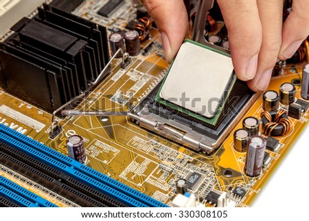 Put computer cpu chip in the socket of motherboard
