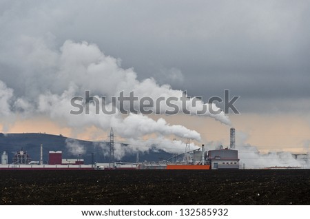 Industrial plant exhausting white smoke into the atmosphere