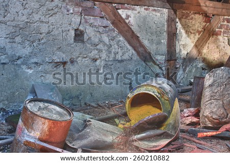 Old, rusty barrel with toxic chemical  waste. Photo was taken on place, where textile factory was wrong  demolished.