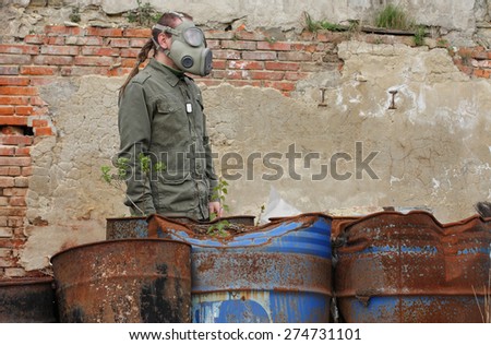 Man with gas mask and green military clothes    after chemical disaster.