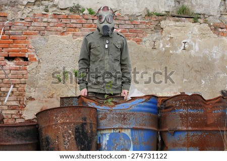 Man with gas mask and green military clothes after chemical disaster.