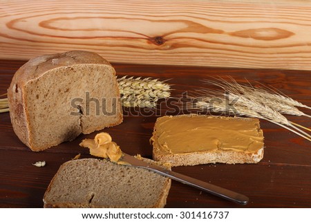 Homemade loaf of  wheat,rye bread and sliced bread with peanut cream.