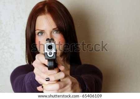 Image of female pointing a gun at somebody breaking and entering