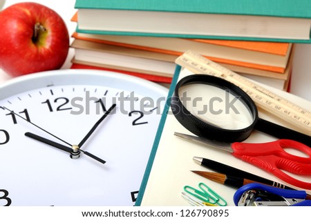 education concept with books, clock, apple and others