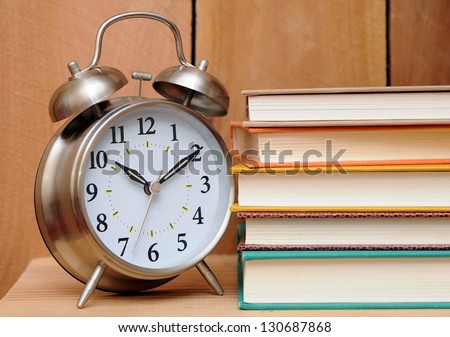 clock with books for time for learning concept