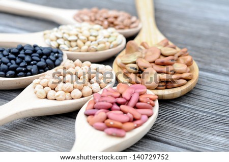 black, light red, chick pea, fava, lablab and pinto beans on grunge table