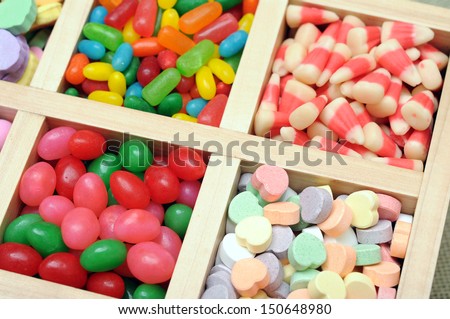 variety of colorful candy in wooden case