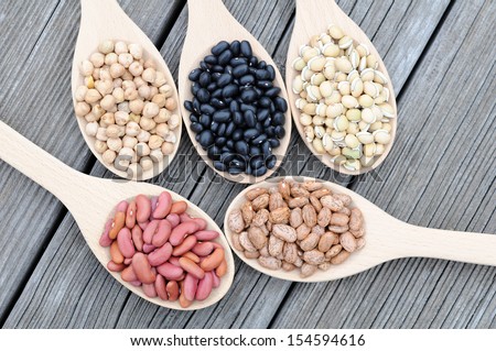 black, light red, chick pea, lablab and pinto beans on grunge table