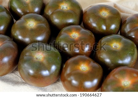 closeup a group of brown tomatoes on napkin