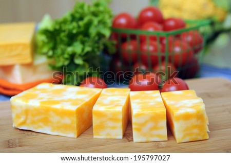 cheese bars  and vegetable on napkin
