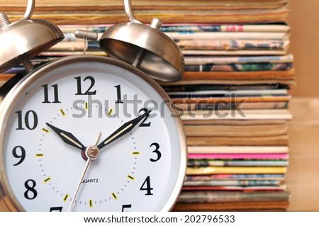 clock with old magazine for time for learning concept