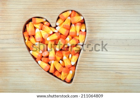 Halloween honey candy corn with rustic wooden frame