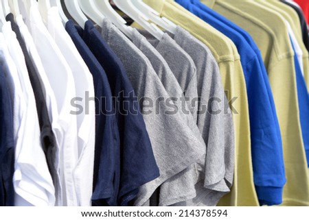 Lots of T-shirts on hangers on the outdoor store