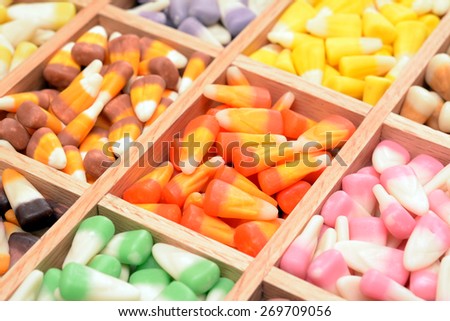 a lot of tooth corn candies in wooden case for background