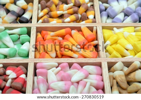 a lot of tooth corn candies in wooden case for background