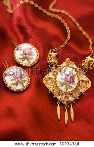 very old jewelry on a red silk