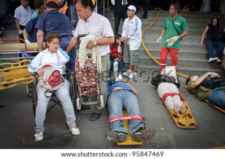 BUENOS AIRES, ARGENTINA - FEB 22: Several injured people wait to be evacuated after a train crashed at Once train station in Buenos Aires on February 22, 2012.