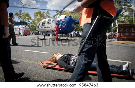BUENOS AIRES, ARGENTINA - FEB 22: An injured woman waits next to a helicopter after a train crashed at Once train station in Buenos Aires on February 22, 2012.
