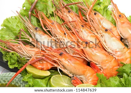 Grilled giant freshwater prawn with lemon ,seafood dish play on the dish on white background