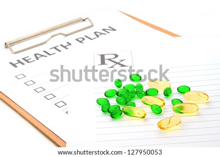 pill capsules resting on medical health plan or patient record form