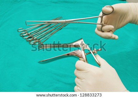 doctor \'s hand graping the Medical equipment ,Gynecologic Speculum
