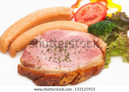 smoke ham steak with smoked sausage on the white plate