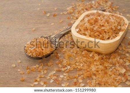 Organic rock candy sugar in wooden spoon