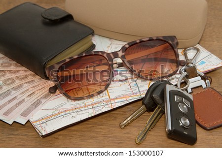 Keys and sunglasses on a road map with wallet,Ready to travel