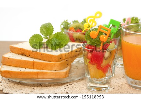 bread slice and fruit salad with orange juice, fusion food