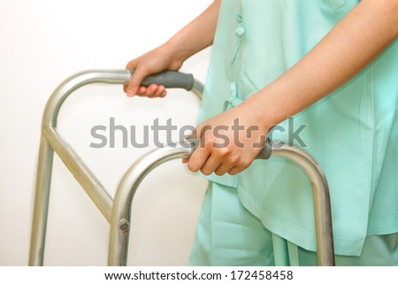 patient woman using a walker,walking aid for training