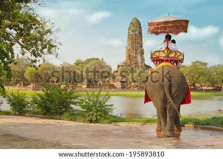 Tourists on an elephant ride tour of the ancient city Ayutaya ,thailand