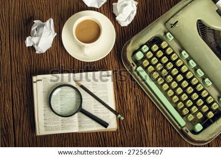 The thai dictionary consider under a magnifier on writer\'s desk with crumpled sheets around