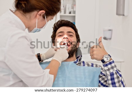 young man and woman in a dental examination at dentist