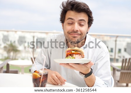 Young man eating a hamburger