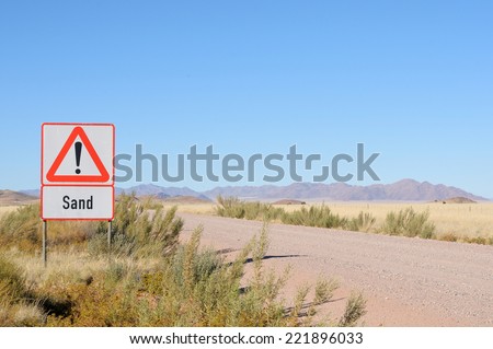 Sand in road warning sign on the C14 road in Namibia