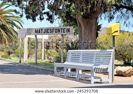 Bench and sign at the historical Matjiesfontein station in the Western Cape Province of South Africa