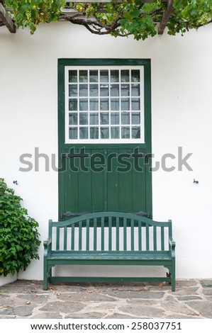 Bench and window with barn doors at the Drosdy, a historic building in Swellendam in the Western Cape Province of South Africa