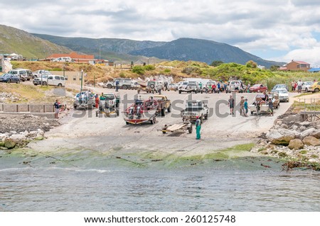 KLEINMOND, SOUTH AFRICA - DECEMBER 23, 2014: Crayfish boats and unidentified people at Kleinmond harbor near Cape Town, South Africa