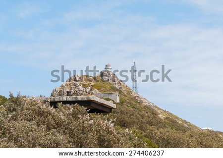 CAPE TOWN, SOUTH AFRICA - DECEMBER 12, 2014:  View from Dias Point at Cape Point towards the historic first lighthouse with a derelict military observation post from World War II in front