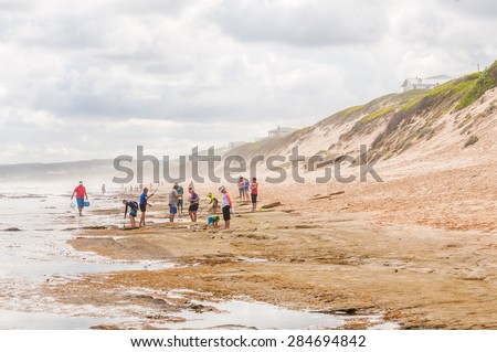 MOSSELBAY, SOUTH AFRICA - DECEMBER 28, 2014: Unidentified tourists enjoying a hazy day at the beach in Reebok