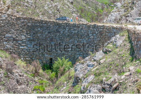 SWARTBERG PASS, SOUTH AFRICA - JANUARY 2, 2015: Built out part of the historic Swartberg (Black Mountain) Pass showing the intricate stonework. The pass is a declared national monument.