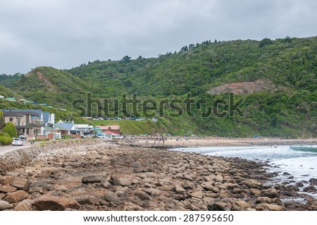GEORGE, SOUTH AFRICA - JANUARY 4, 2015: Unidentified people, holiday homes and a caravan park at Victoria Bay, South Africa at low tide