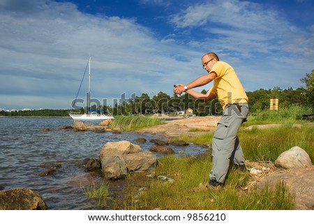 Man throwing stone on a beach