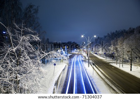 Traffic light stream in city at night in winter