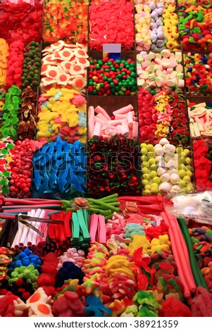 Variety of candys and gum drops at a market stall.