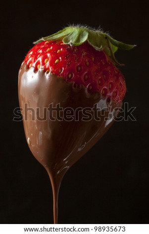 strawberry with chocolate black background